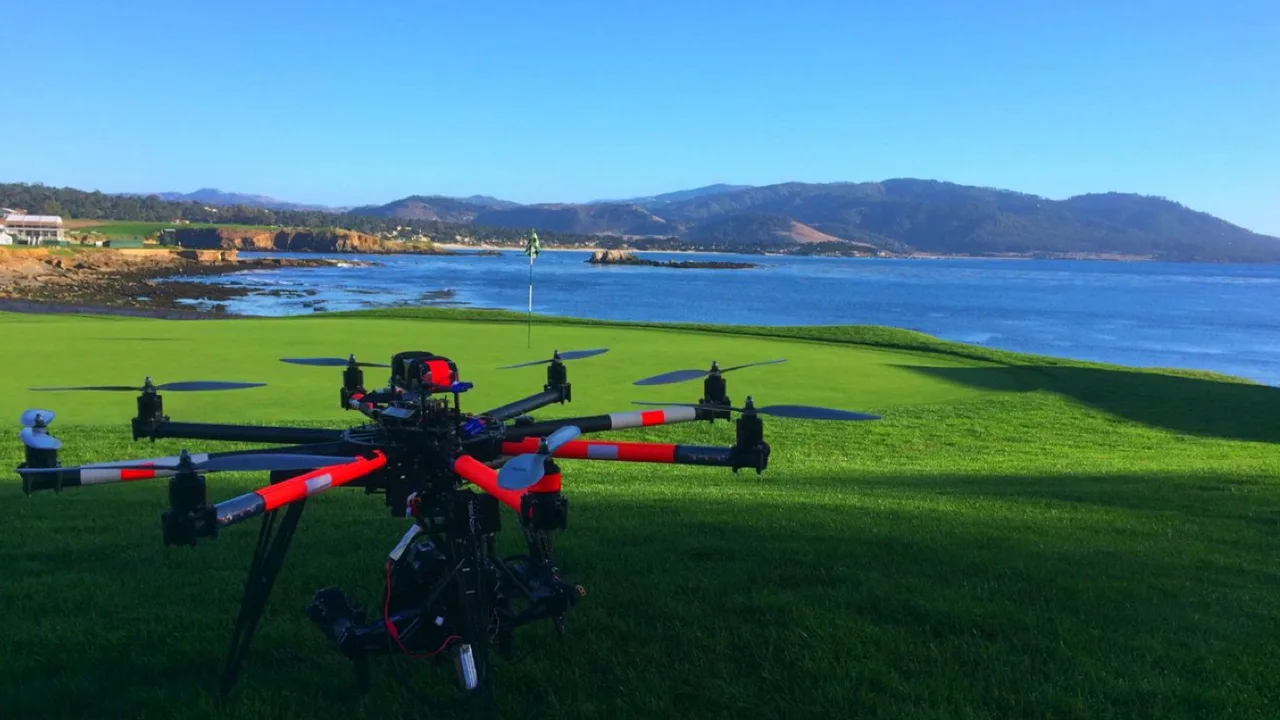 Kaze Aerial octocopter drone on the green at Pebble Beach with the Pacific behind it